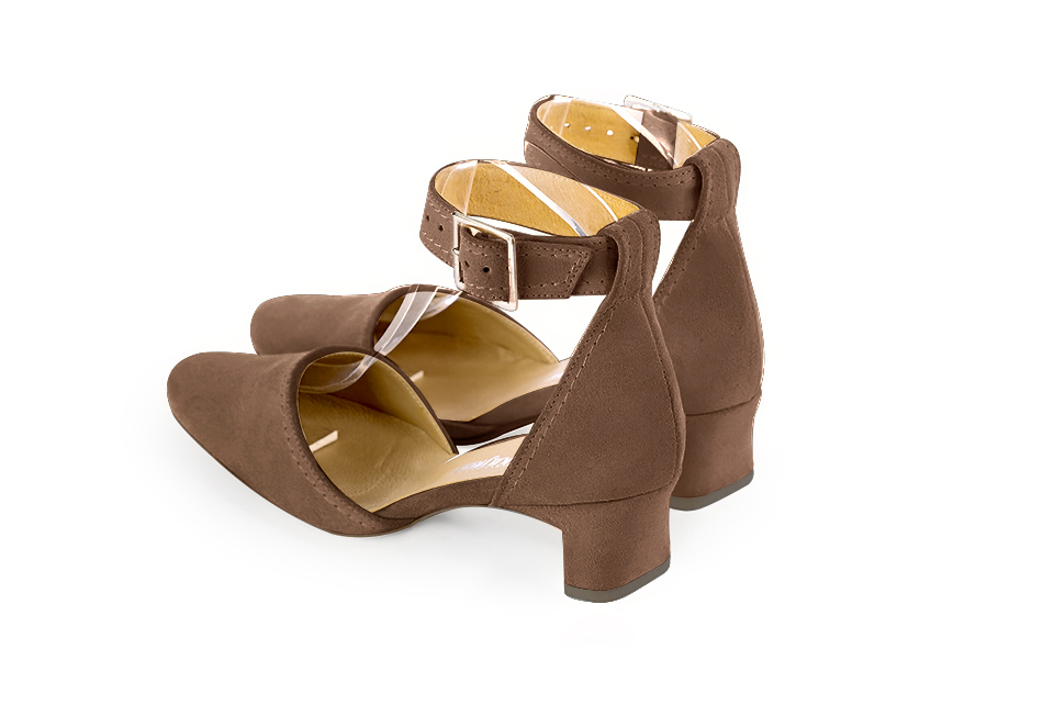 Women's chocolate brown open side dress shoes, with a strap around the ankle. Round toe. Low kitten heels - Rear view